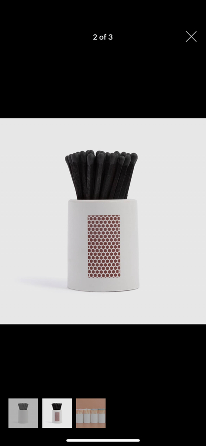 White Round Vessel with All Black Matchsticks is